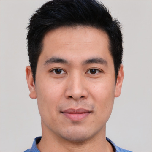 Joyful white young-adult male with short  black hair and brown eyes