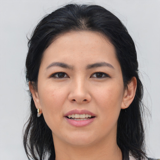 Joyful asian young-adult female with long  brown hair and brown eyes