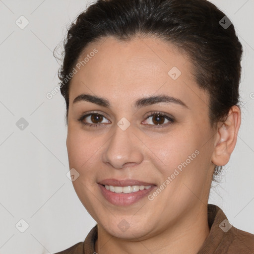 Joyful white young-adult female with medium  brown hair and brown eyes