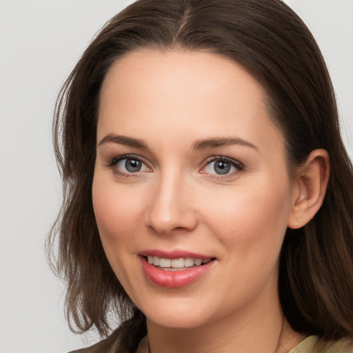 Joyful white young-adult female with long  brown hair and brown eyes