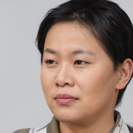 Joyful asian young-adult female with medium  brown hair and brown eyes
