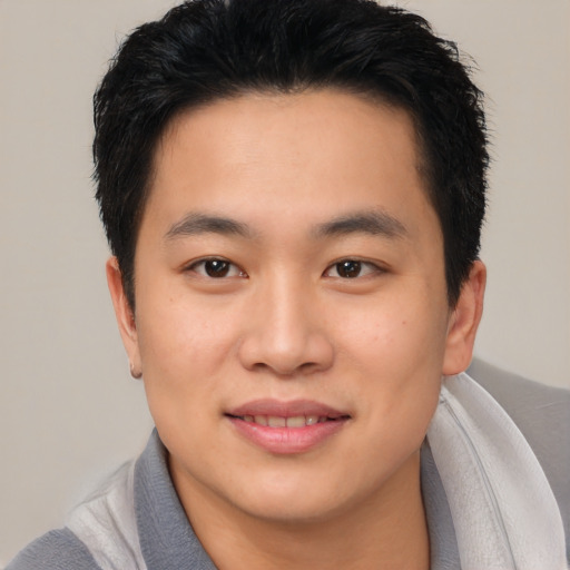 Joyful asian young-adult male with short  black hair and brown eyes