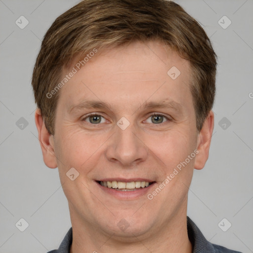 Joyful white adult male with short  brown hair and grey eyes