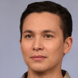 Joyful white adult male with short  brown hair and brown eyes