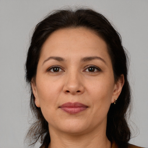 Joyful white adult female with medium  brown hair and brown eyes