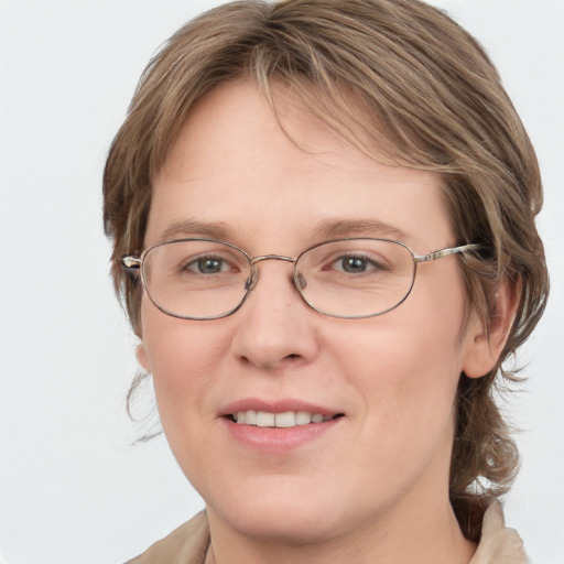 Joyful white adult female with medium  brown hair and blue eyes