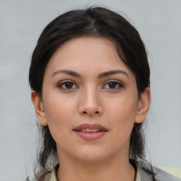 Joyful asian young-adult female with medium  brown hair and brown eyes