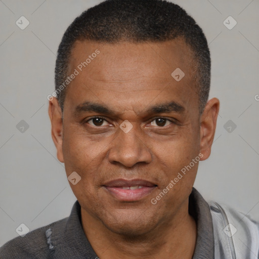 Joyful black adult male with short  black hair and brown eyes