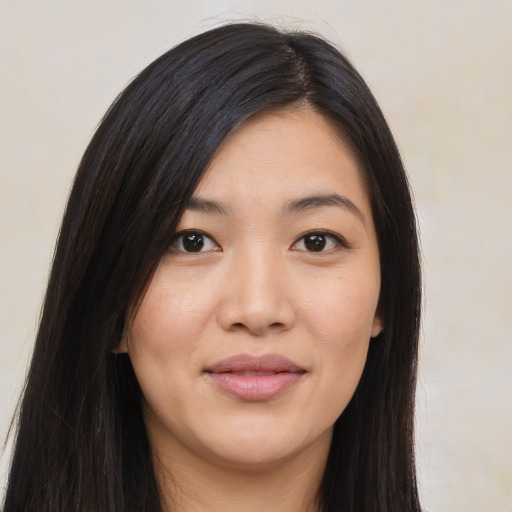 Joyful asian young-adult female with long  black hair and brown eyes