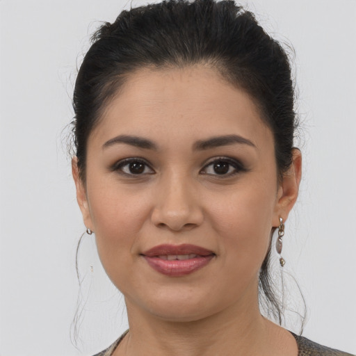 Joyful latino young-adult female with medium  brown hair and brown eyes