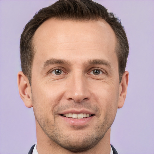 Joyful white adult male with short  brown hair and brown eyes