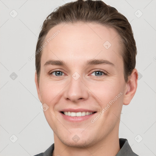 Joyful white young-adult female with short  brown hair and grey eyes