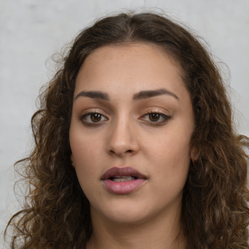 Neutral white young-adult female with long  brown hair and brown eyes