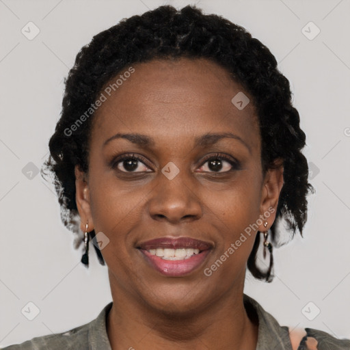 Joyful black adult female with short  black hair and brown eyes