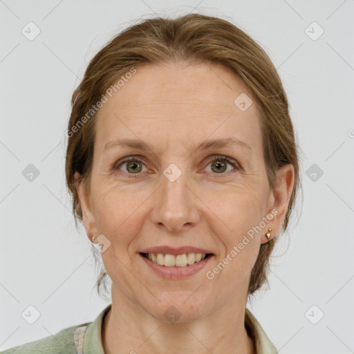 Joyful white adult female with medium  brown hair and grey eyes