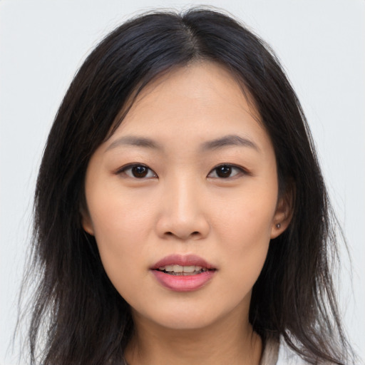 Joyful asian young-adult female with long  brown hair and brown eyes