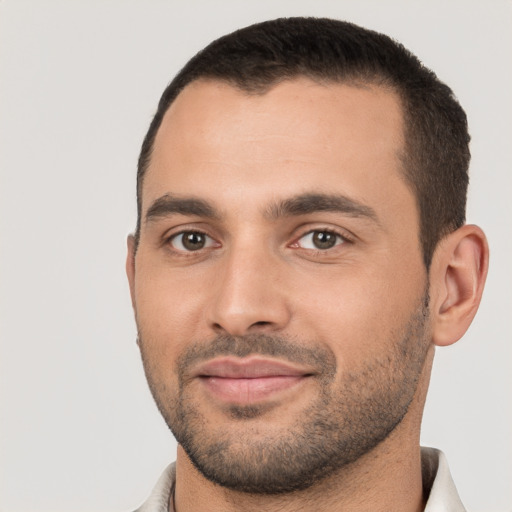 Joyful white young-adult male with short  black hair and brown eyes