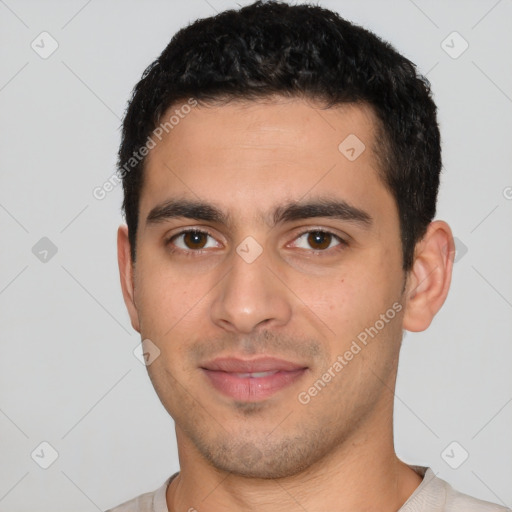 Joyful white young-adult male with short  black hair and brown eyes