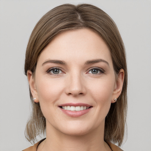 Joyful white young-adult female with medium  brown hair and grey eyes