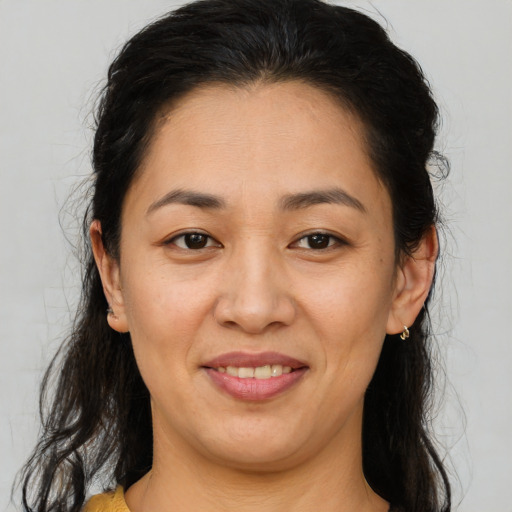 Joyful latino adult female with medium  brown hair and brown eyes