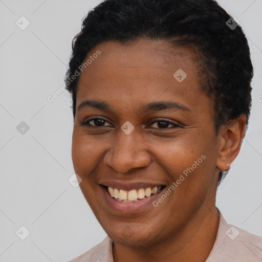 Joyful black young-adult female with short  brown hair and brown eyes