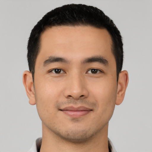 Joyful latino young-adult male with short  black hair and brown eyes