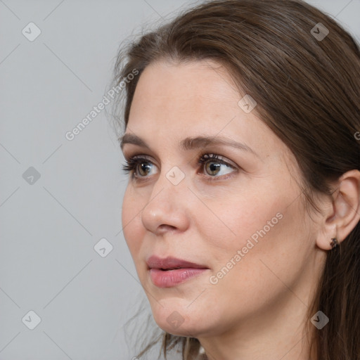 Joyful white adult female with long  brown hair and grey eyes