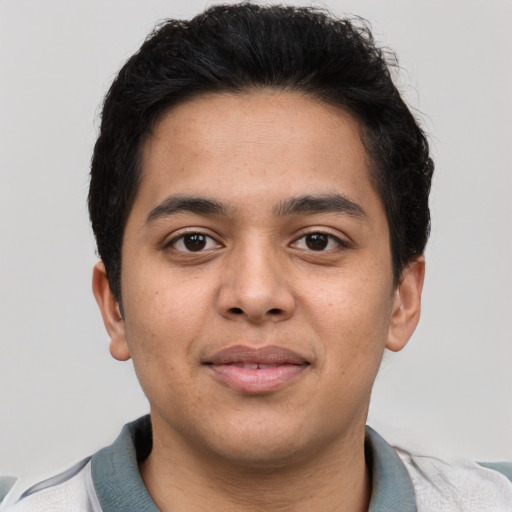 Joyful latino young-adult male with short  brown hair and brown eyes