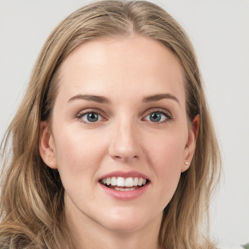 Joyful white young-adult female with long  brown hair and blue eyes