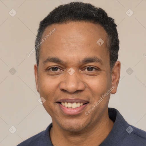 Joyful latino adult male with short  black hair and brown eyes