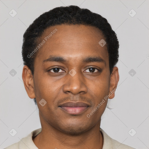 Joyful black young-adult male with short  black hair and brown eyes