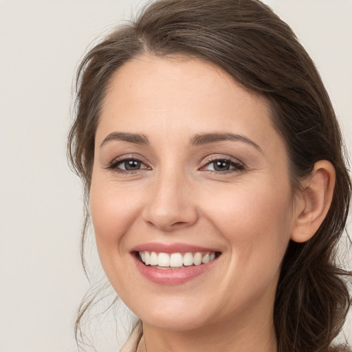 Joyful white young-adult female with medium  brown hair and brown eyes