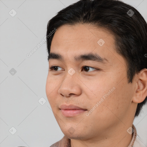 Joyful white young-adult male with short  black hair and brown eyes