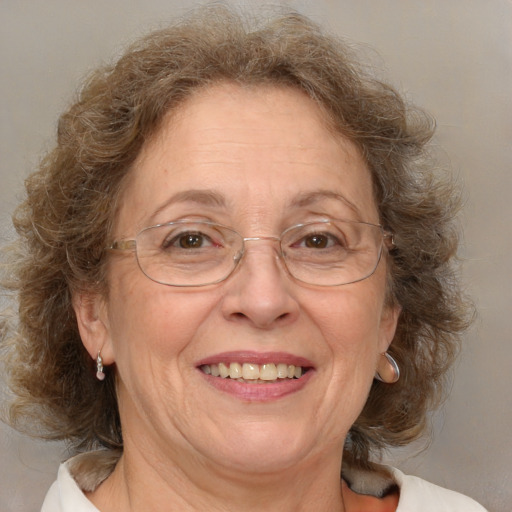 Joyful white middle-aged female with medium  brown hair and blue eyes