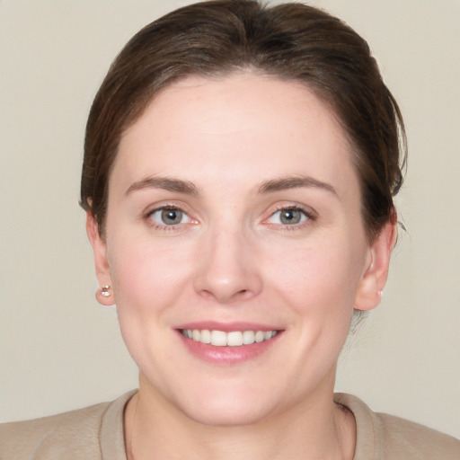 Joyful white young-adult female with short  brown hair and grey eyes