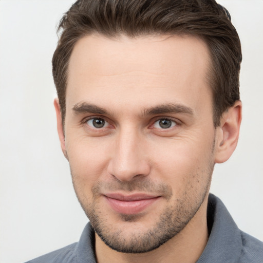 Joyful white young-adult male with short  brown hair and brown eyes