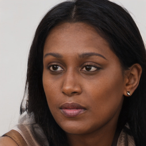 Neutral black young-adult female with long  brown hair and brown eyes