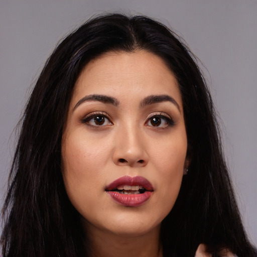 Joyful asian young-adult female with long  black hair and brown eyes