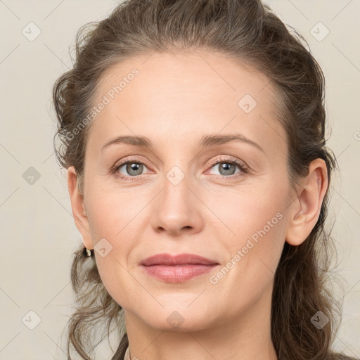 Joyful white adult female with medium  brown hair and grey eyes