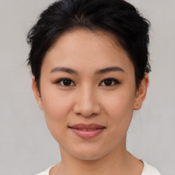 Joyful asian young-adult female with short  brown hair and brown eyes