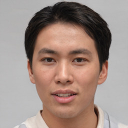 Joyful asian young-adult male with short  brown hair and brown eyes