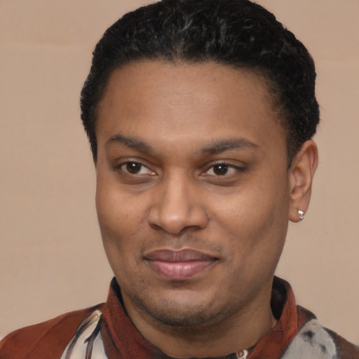 Joyful latino young-adult male with short  black hair and brown eyes