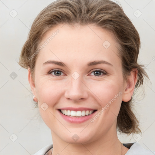 Joyful white young-adult female with medium  brown hair and grey eyes