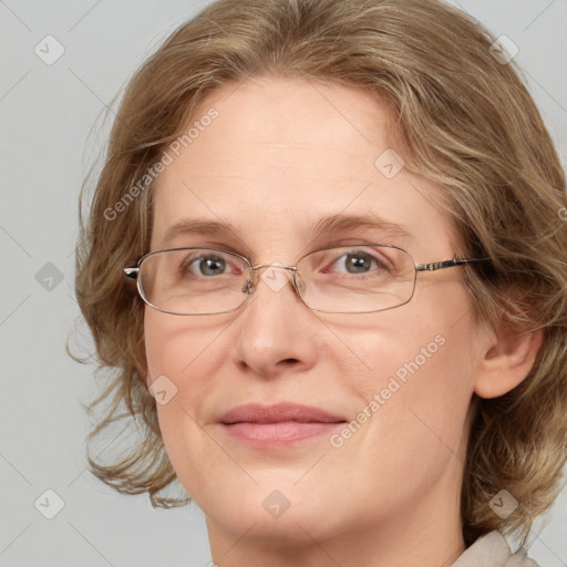 Joyful white adult female with medium  brown hair and blue eyes