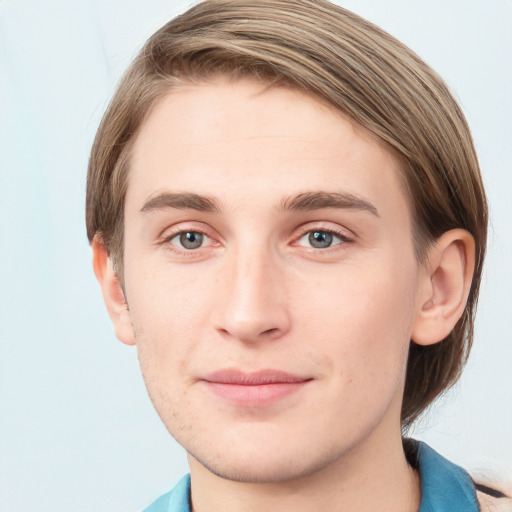 Joyful white young-adult male with short  brown hair and blue eyes