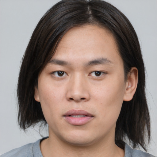 Joyful asian young-adult male with medium  brown hair and brown eyes