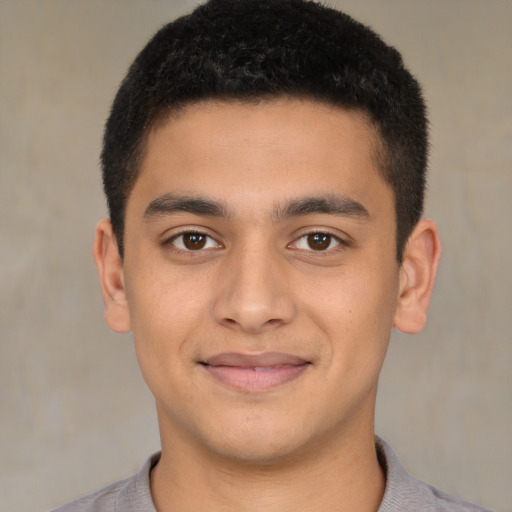 Joyful latino young-adult male with short  brown hair and brown eyes