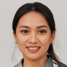 Joyful latino young-adult female with medium  brown hair and brown eyes