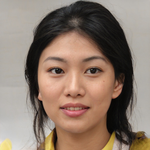 Joyful asian young-adult female with medium  brown hair and brown eyes