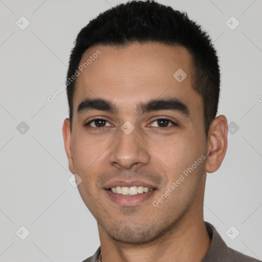 Joyful white young-adult male with short  black hair and brown eyes